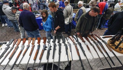 
              In this Jan. 26, 2013, photo, guns are displayed on a table on display during the annual New York State Arms Collectors Association Albany Gun Show at the Empire State Plaza Convention 